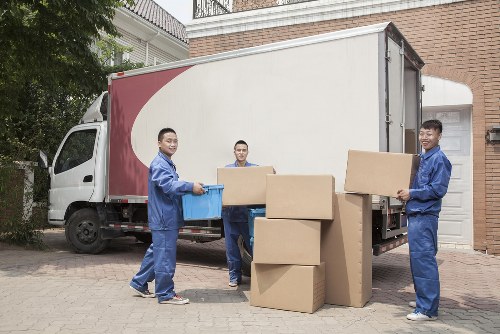 Man and van helping with a move in Bethnal Green street with flats and parked vehicles
