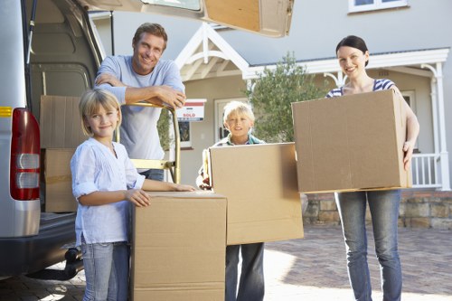 Mover using PPE while carrying furniture through a narrow space