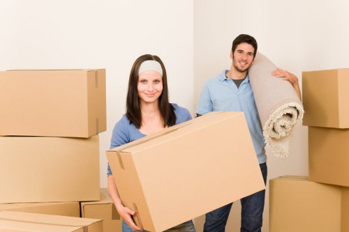 Professional movers handling furniture and boxes in a Bethnal Green flat